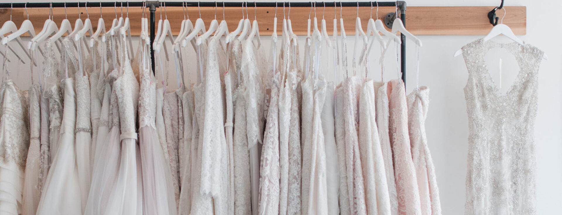 A long shot of the white wedding frocks hanging in a row